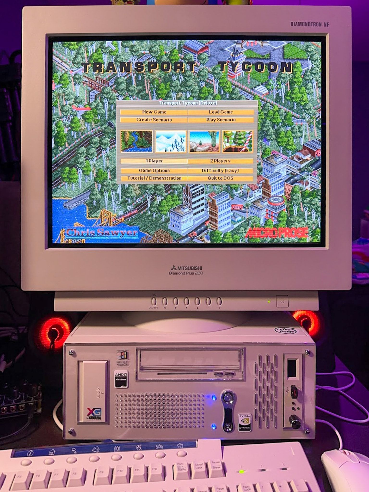 A beige PC and Monitor running Transport Tycoon on DOS